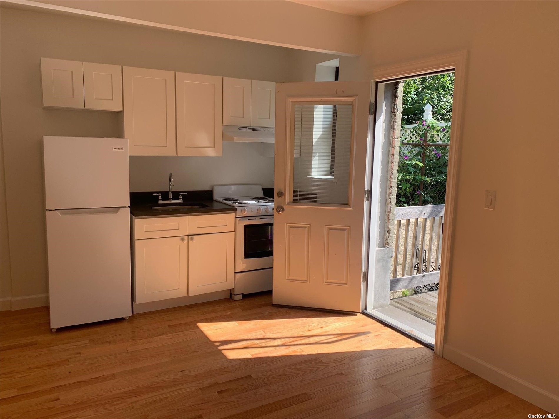 a kitchen with a refrigerator a stove a microwave and cabinets