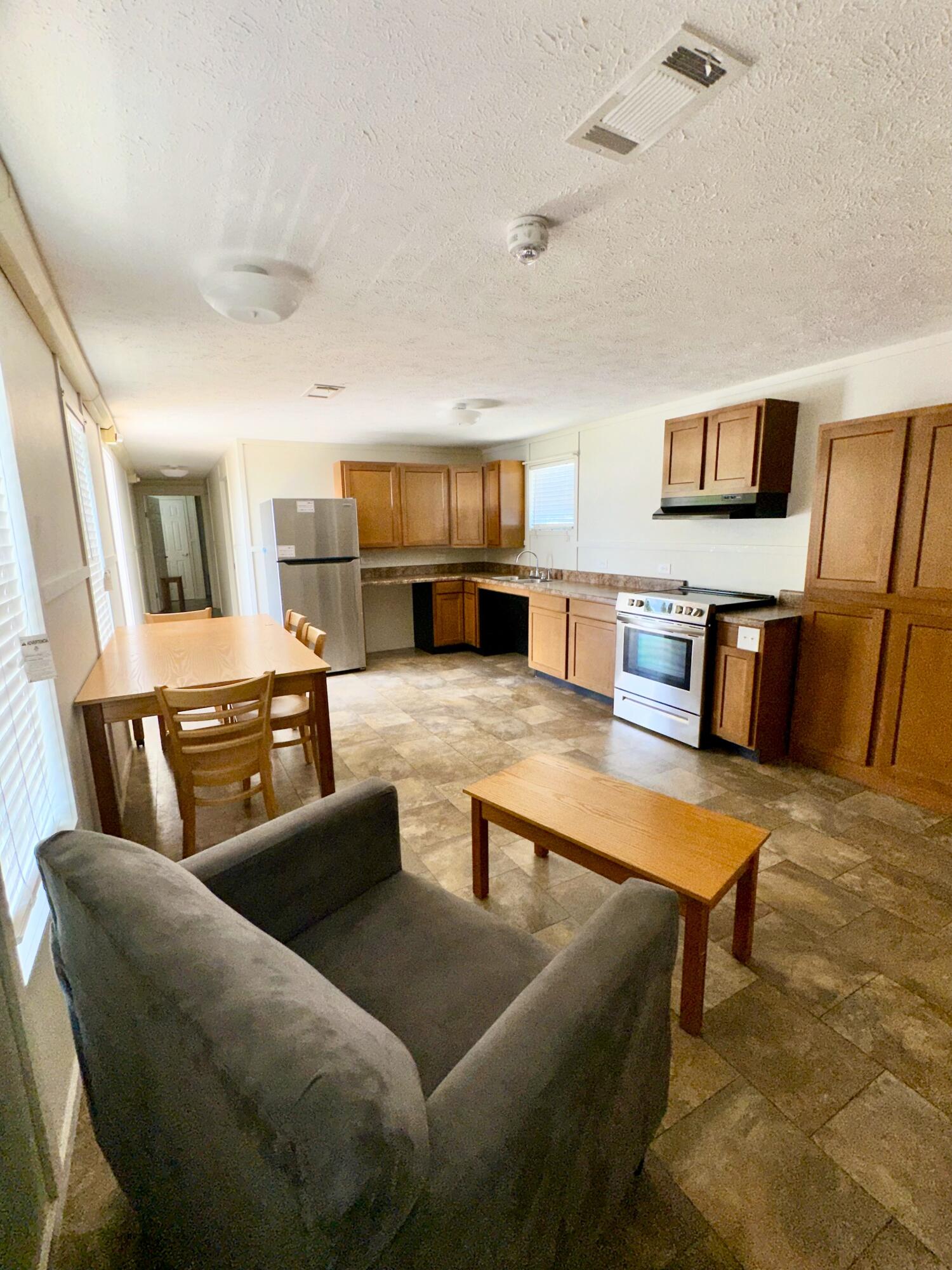 a living room with furniture and kitchen view