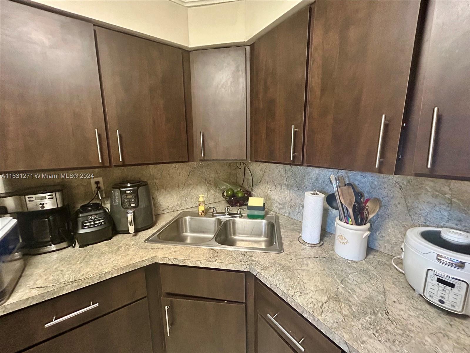 a kitchen with a sink and cabinets