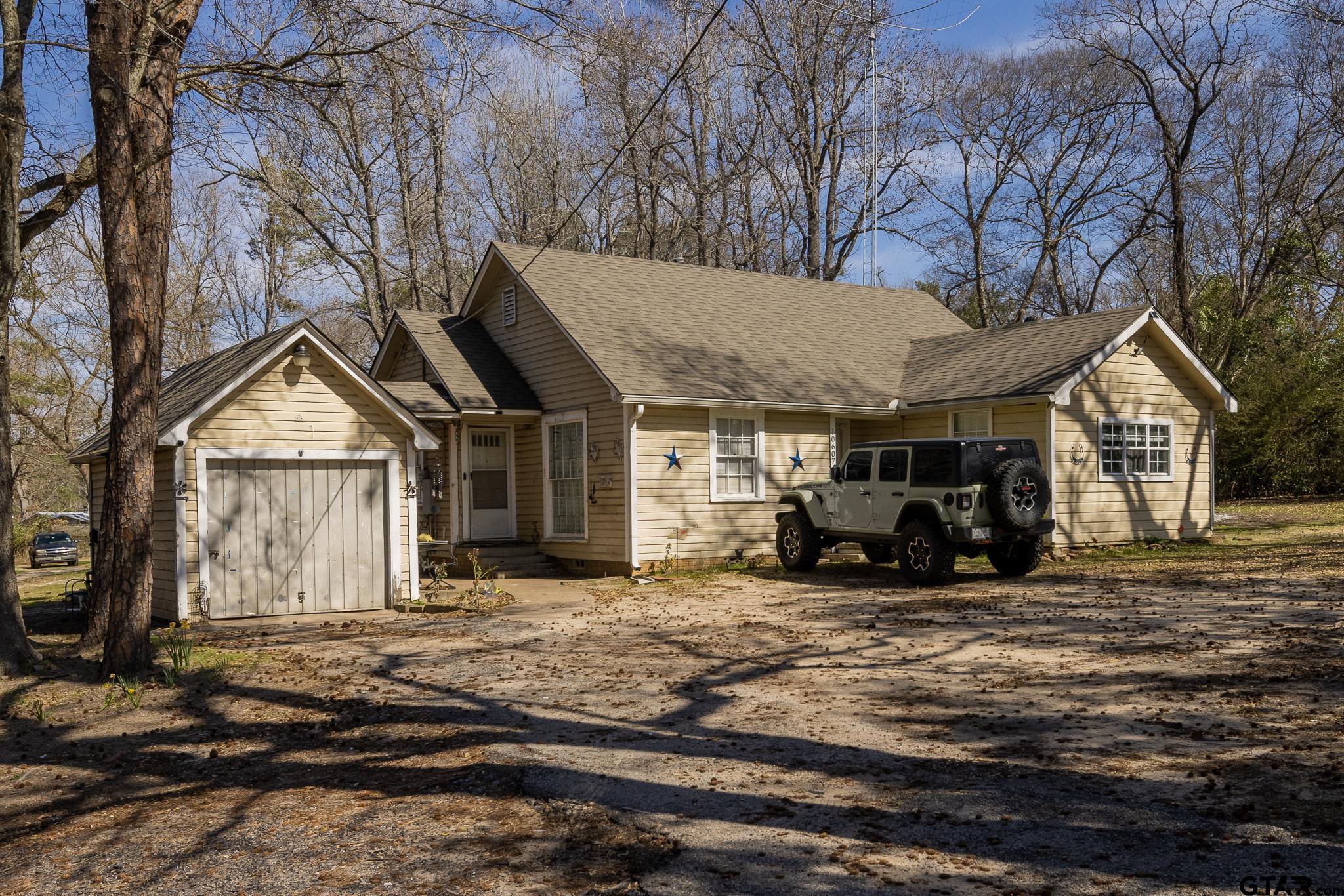 a view of a house with large trees in front of it