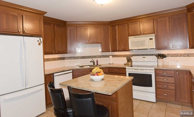 a kitchen with stainless steel appliances a stove a sink and a refrigerator