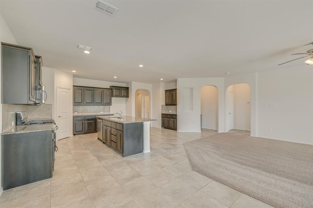 a large white kitchen with a large window