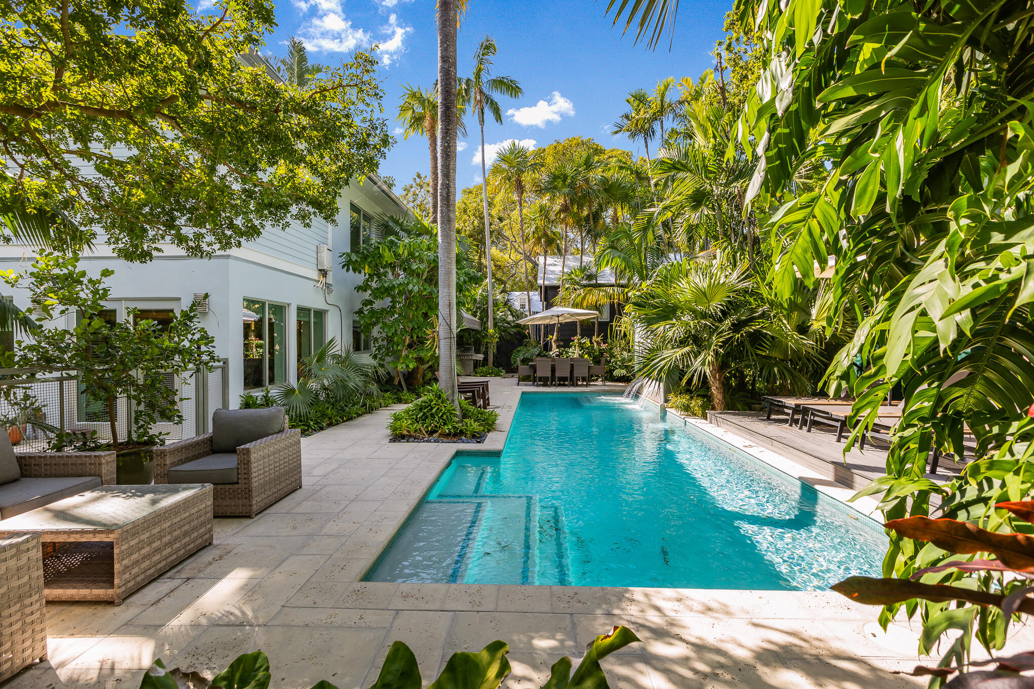 a view of house with swimming pool outdoor seating