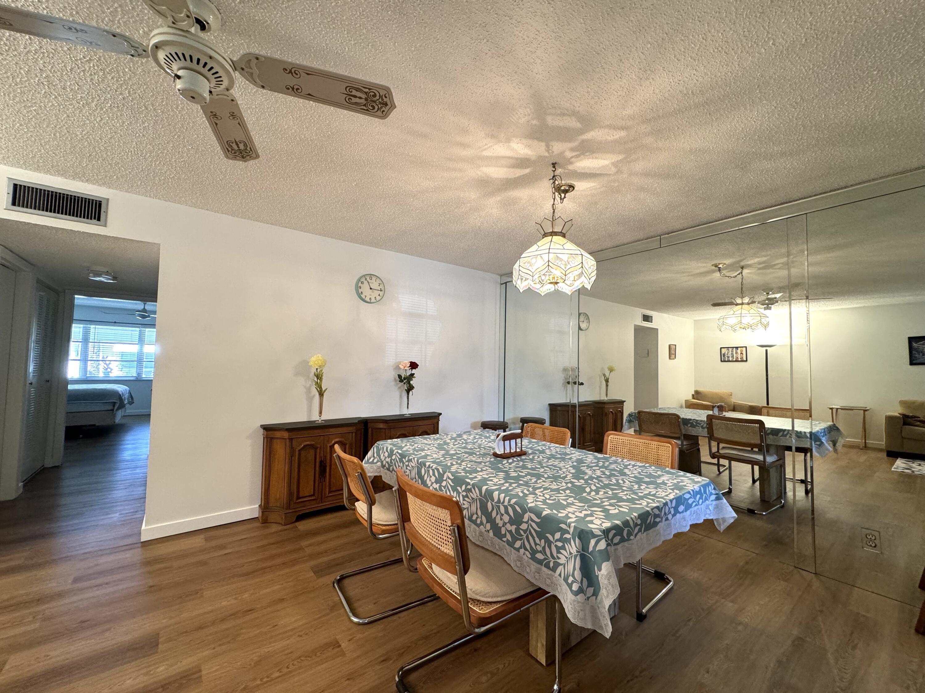 a living room with dining table and wooden floor