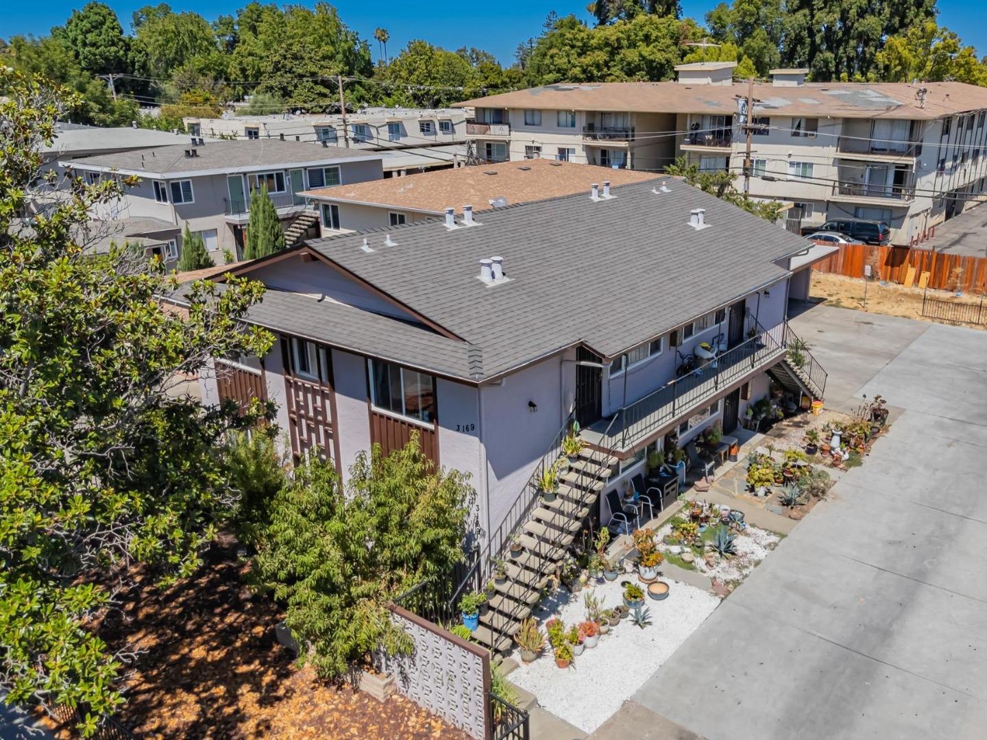 an aerial view of a house with a yard and balcony