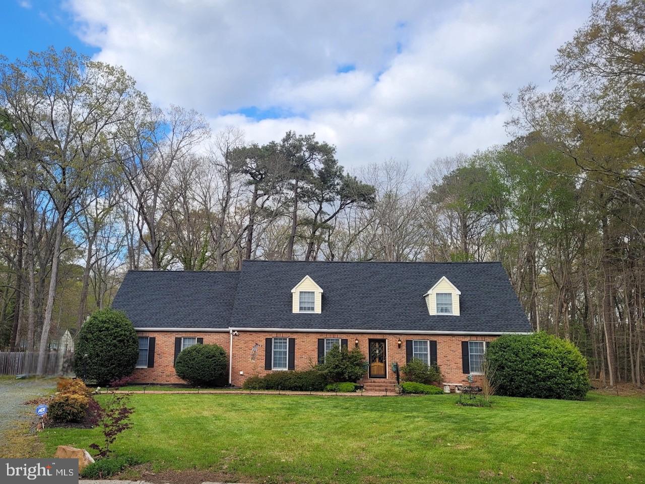 a view of house with a yard