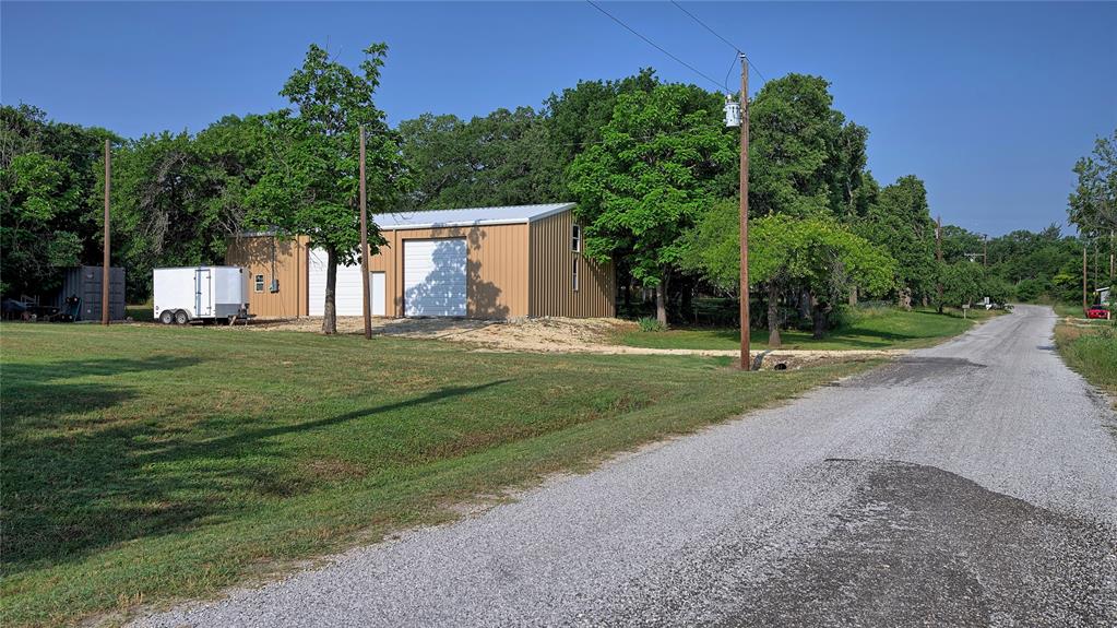 a view of a house with a yard and tree s