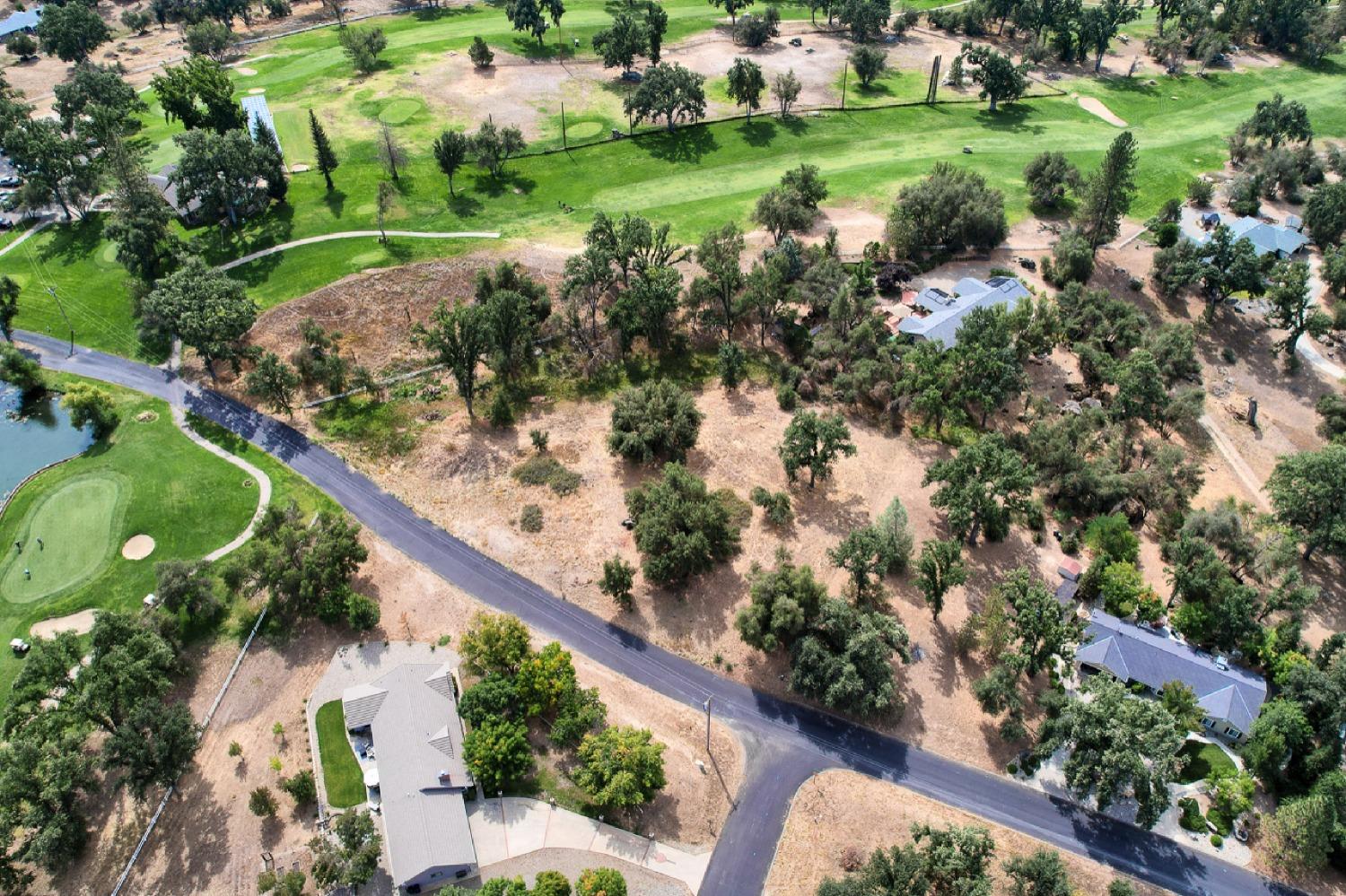 an aerial view of a residential houses with outdoor space and street view