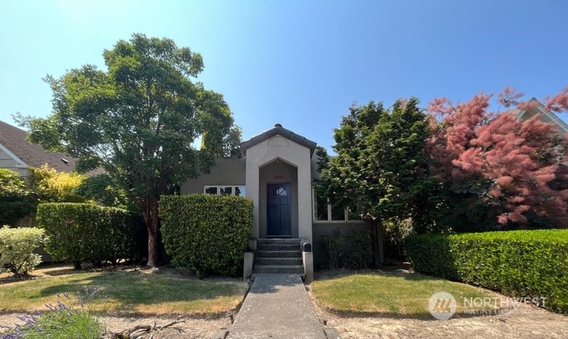 a front view of a house with garden