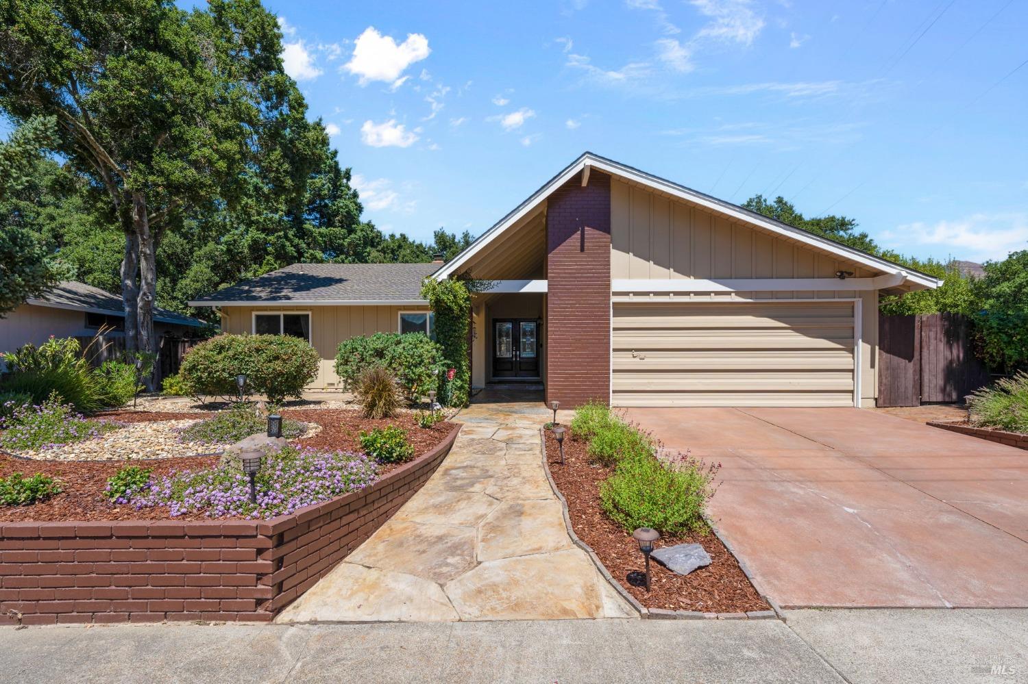 a front view of a house with garden