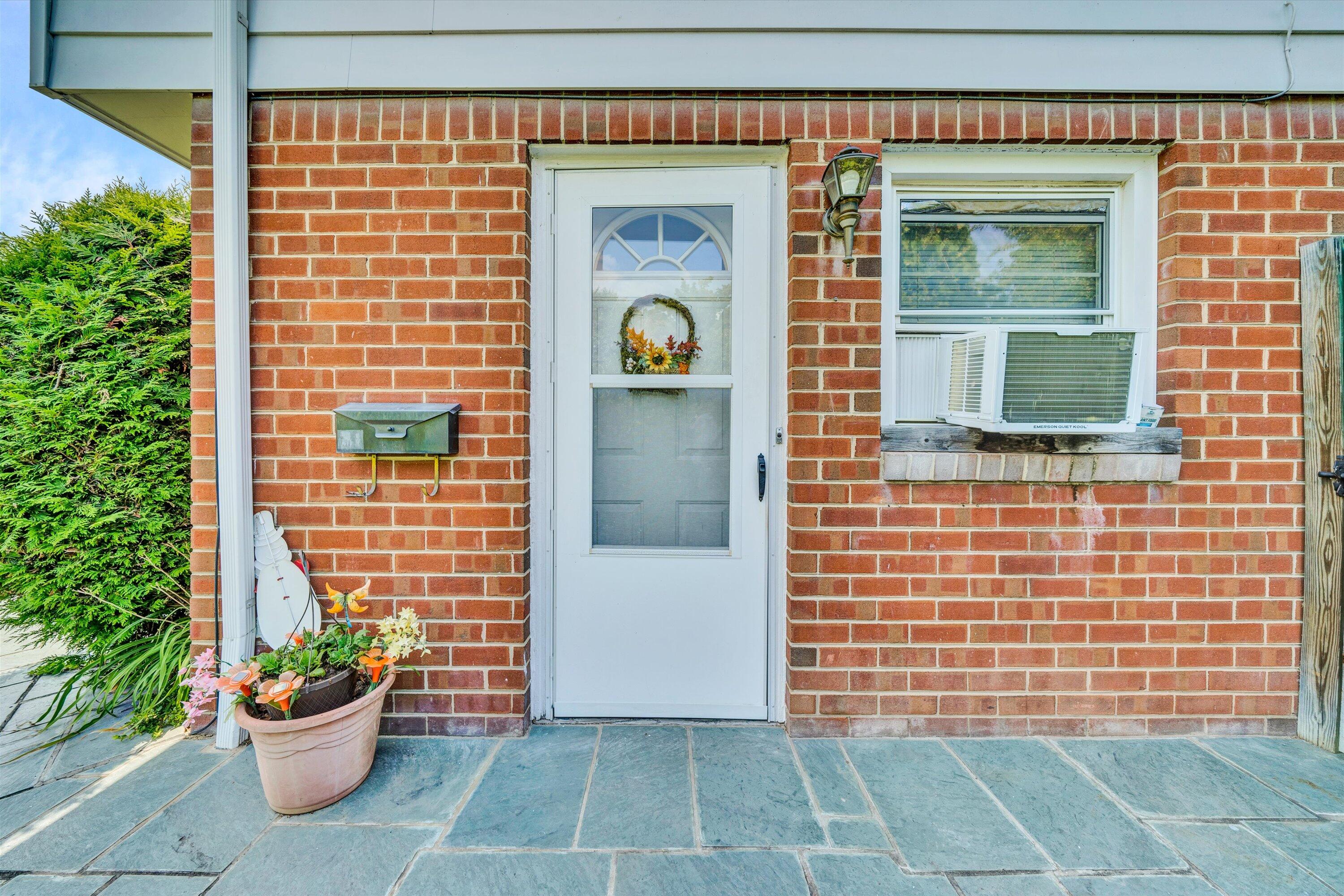 a front view of a house with a garden