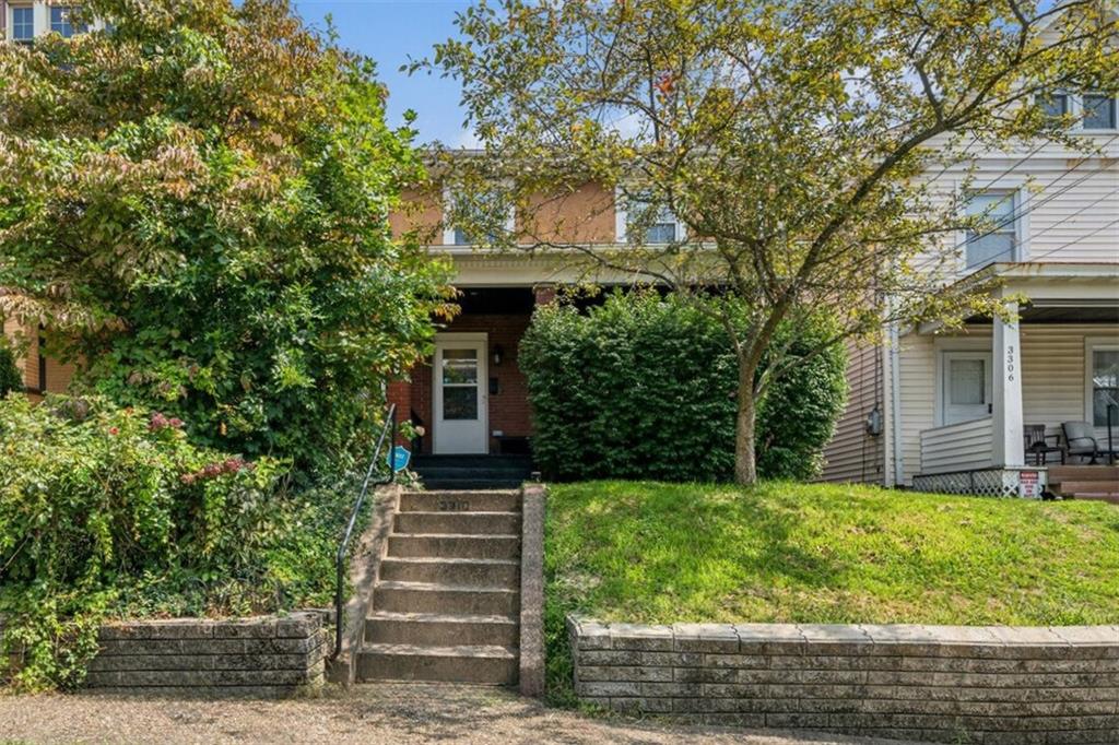 a front view of a house with a yard