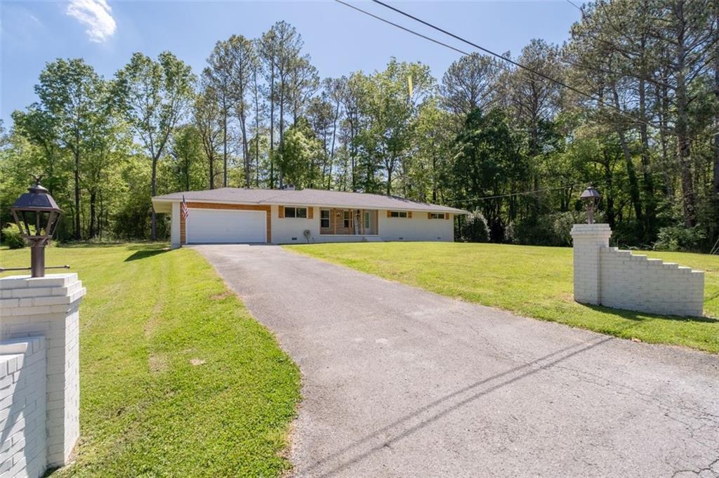 a view of a house with a yard and sitting area