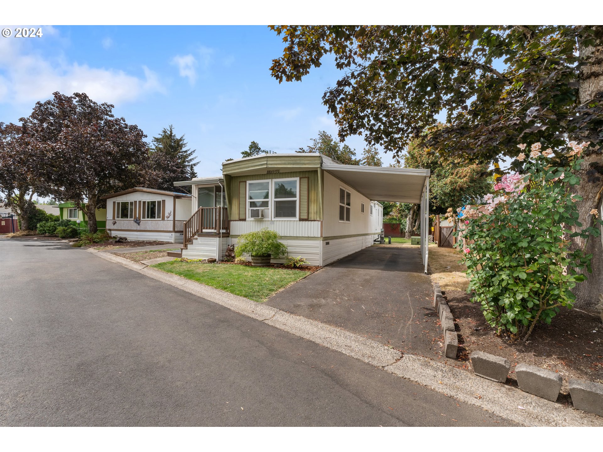 a front view of a house with a yard and a garage