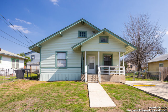 a front view of a house with a yard and seating space