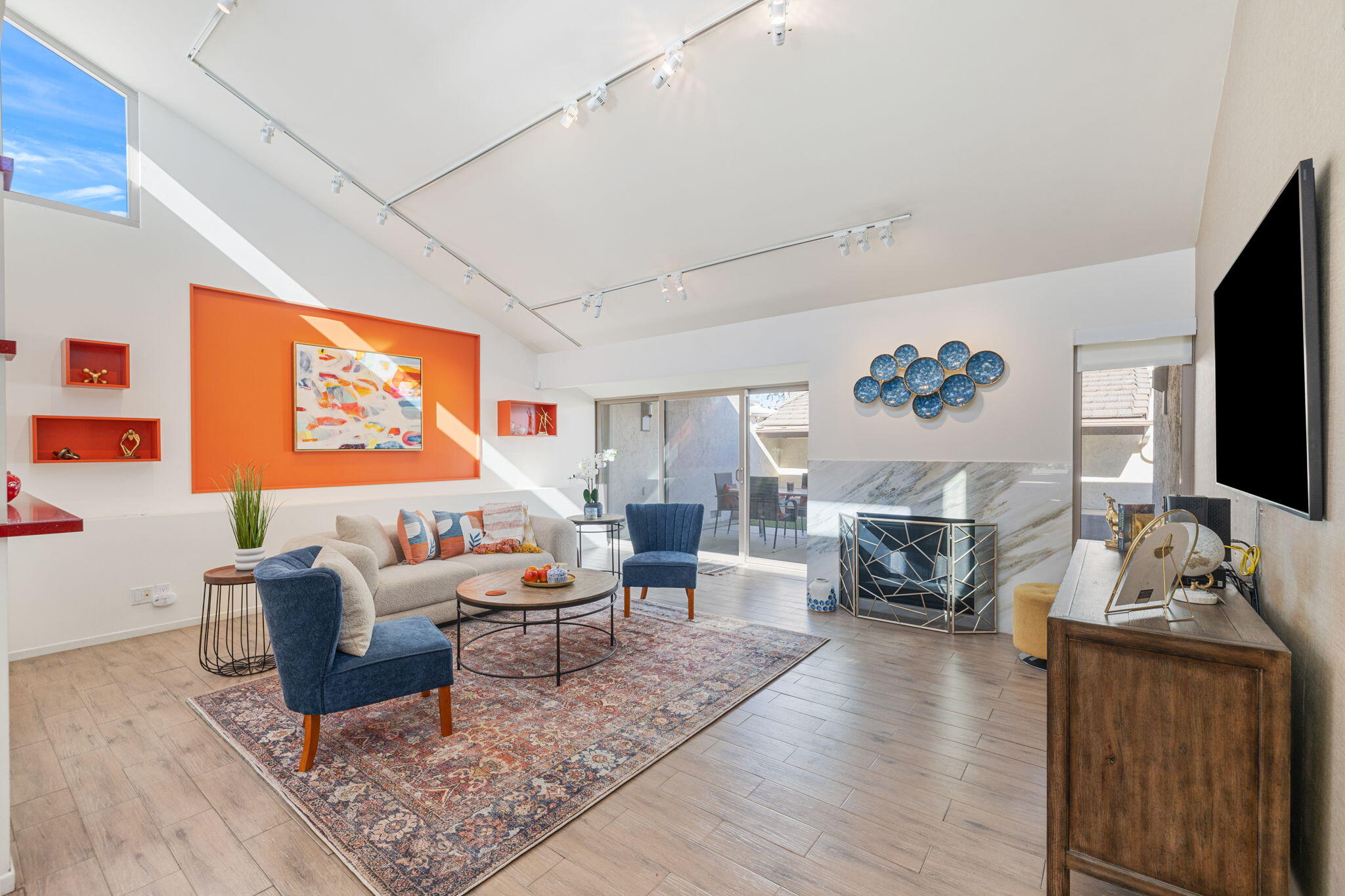 a living room with furniture flat screen tv and wooden floor