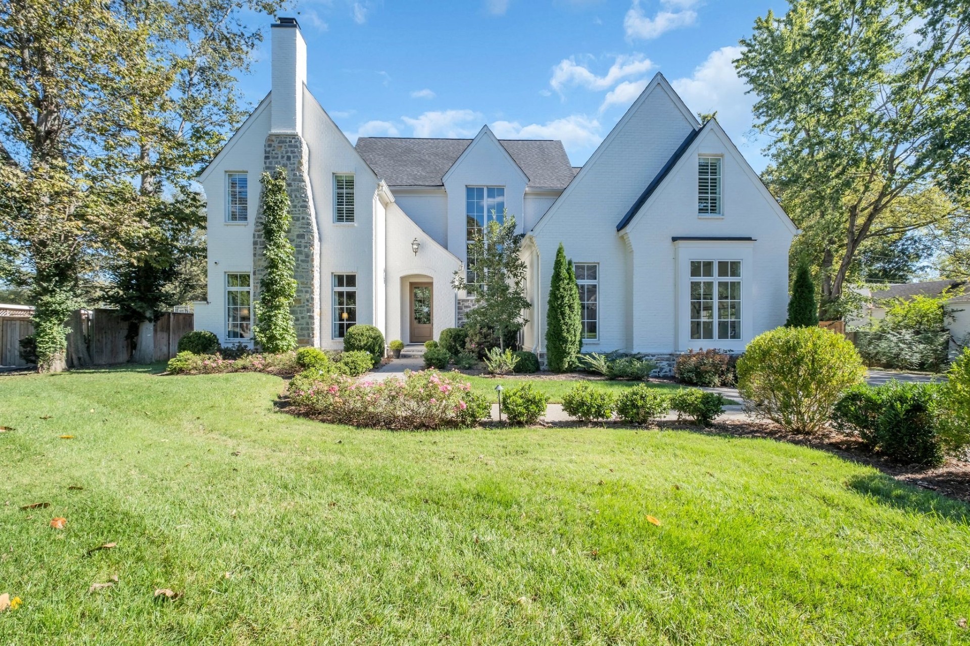 a front view of a house with a garden