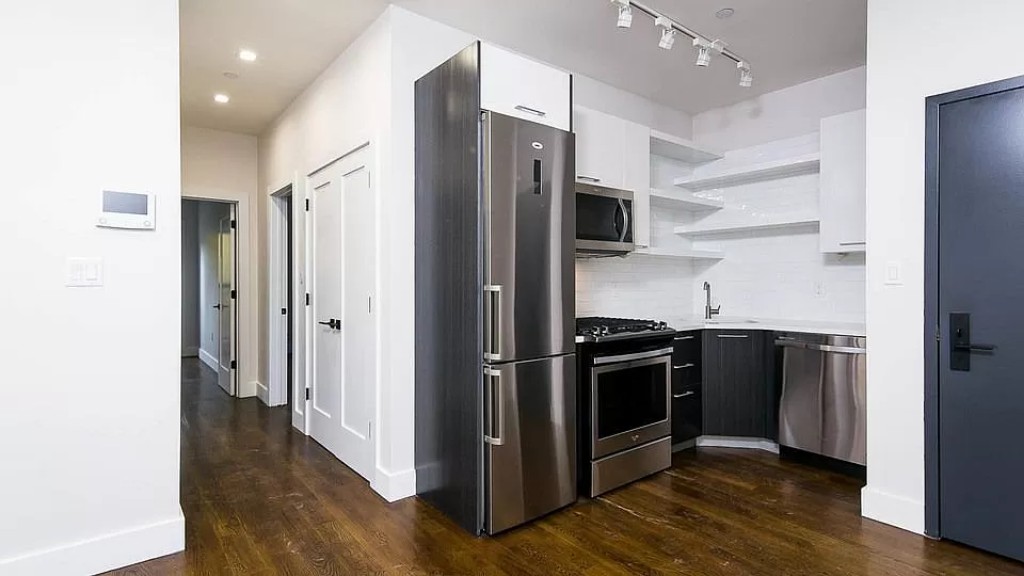 a kitchen with stainless steel appliances a refrigerator and a stove top oven