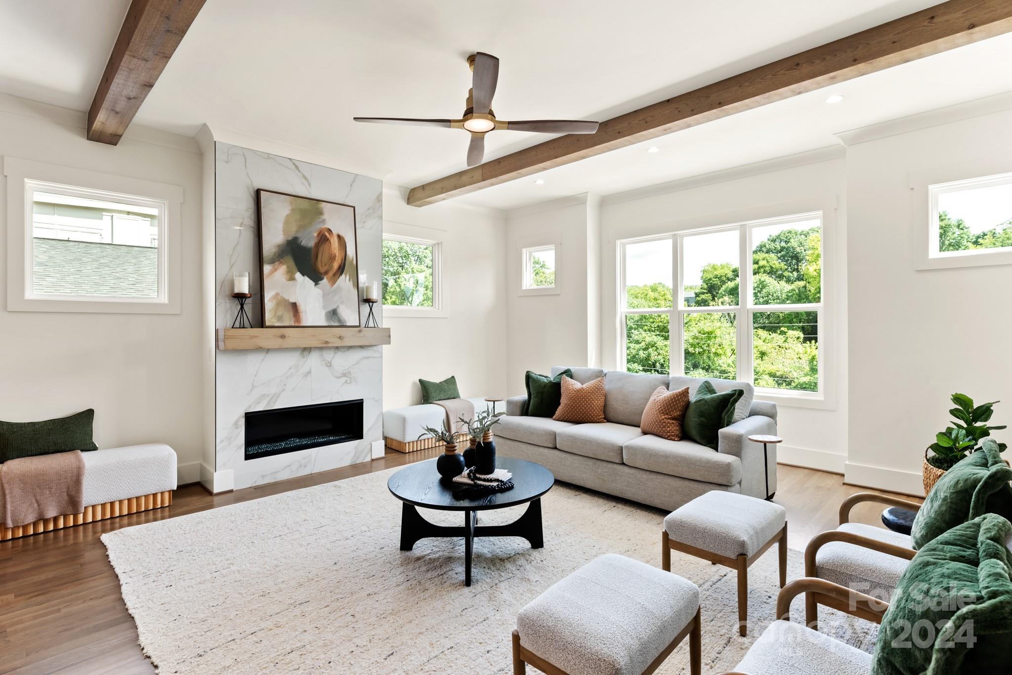 a living room with furniture fireplace and window