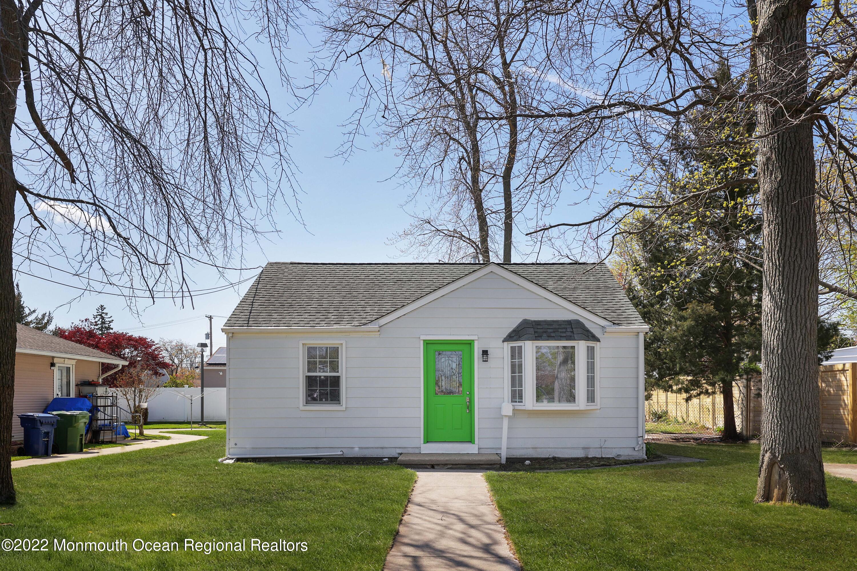 a front view of house with yard and green space