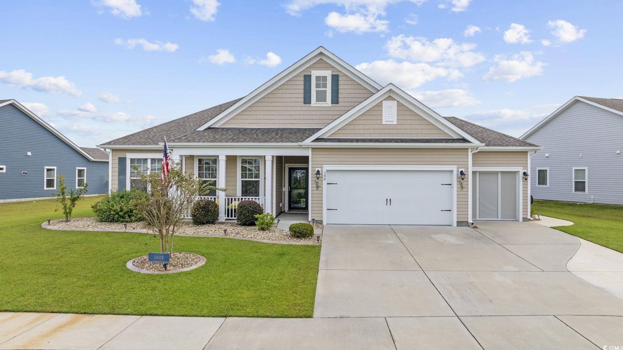 View of front of house featuring a porch, a garage