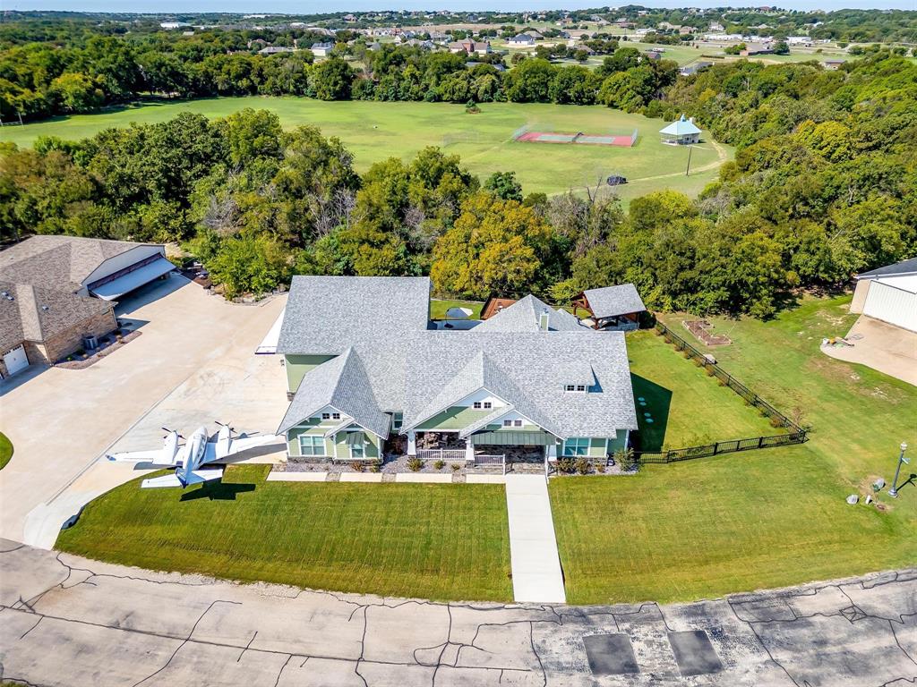 an aerial view of residential houses with outdoor space and swimming pool