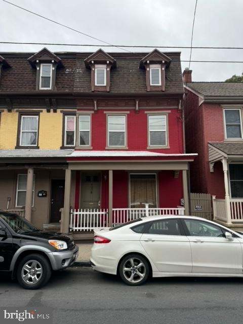 a front view of a house with parking space