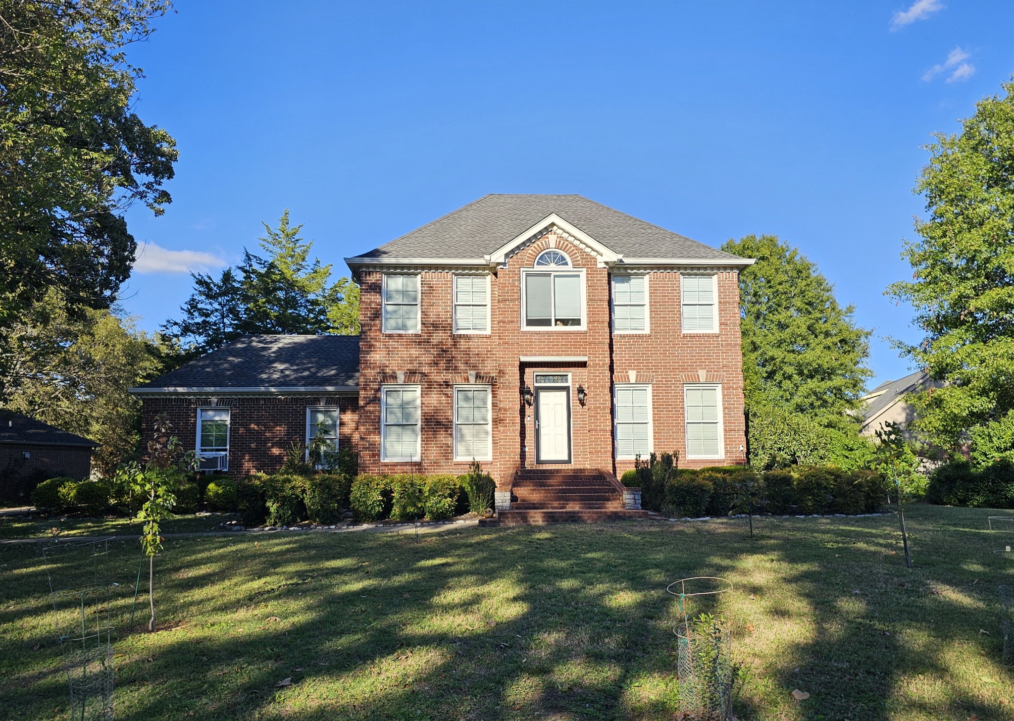 a front view of a house with a yard