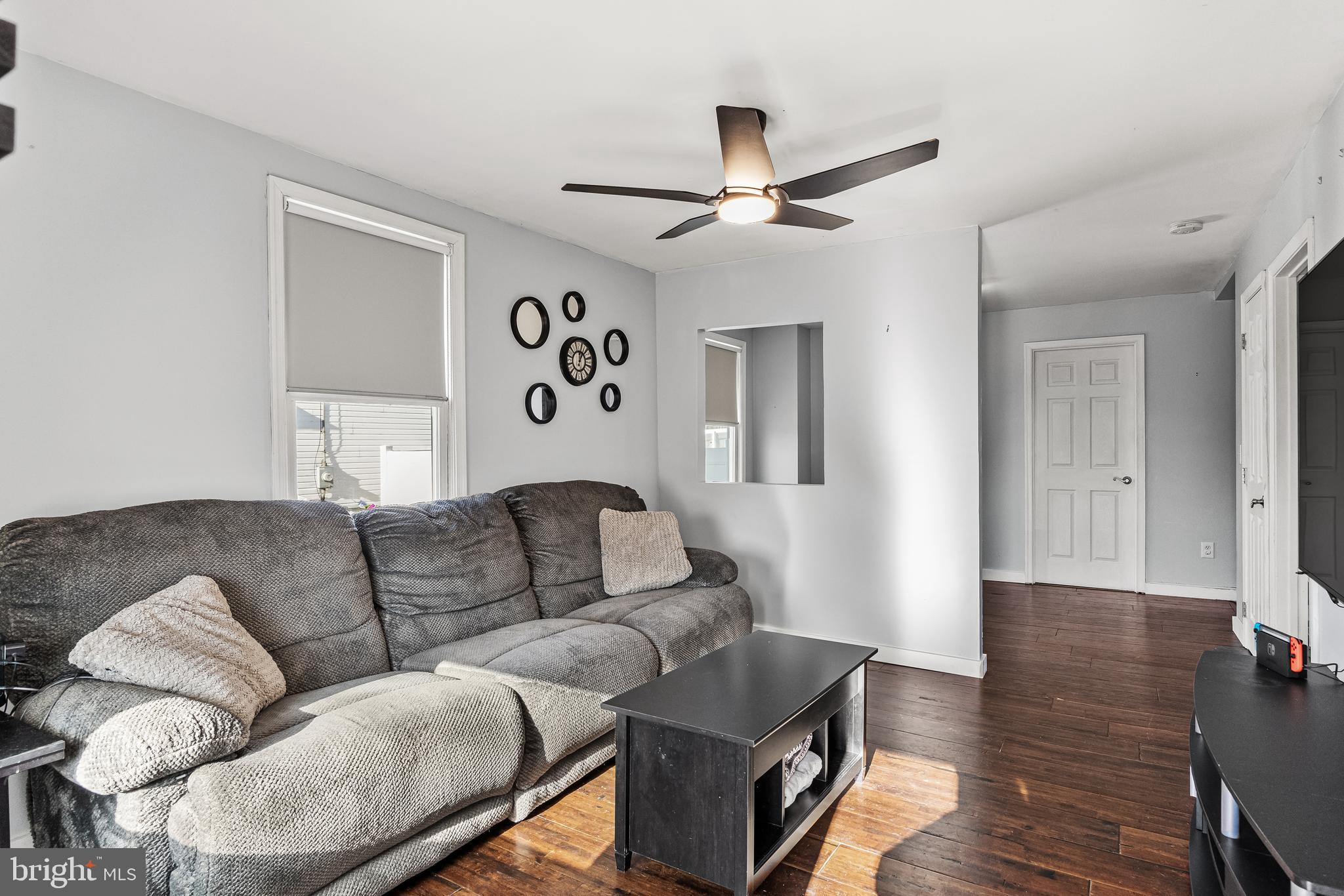 a living room with couches and furniture with wooden floor