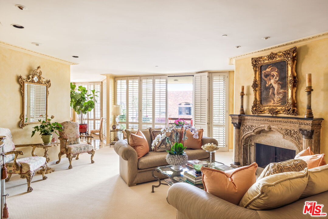 a living room with furniture fireplace and a large window