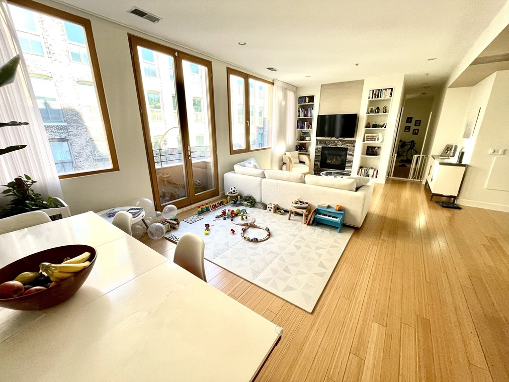 a living room with furniture and large windows