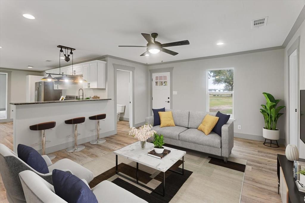 a living room with furniture and kitchen view