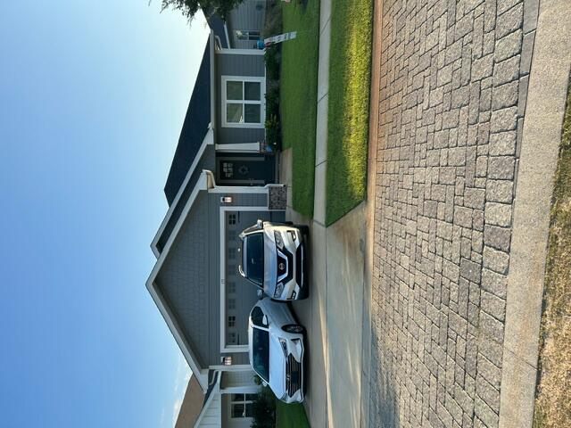 a front view of a house with a garden