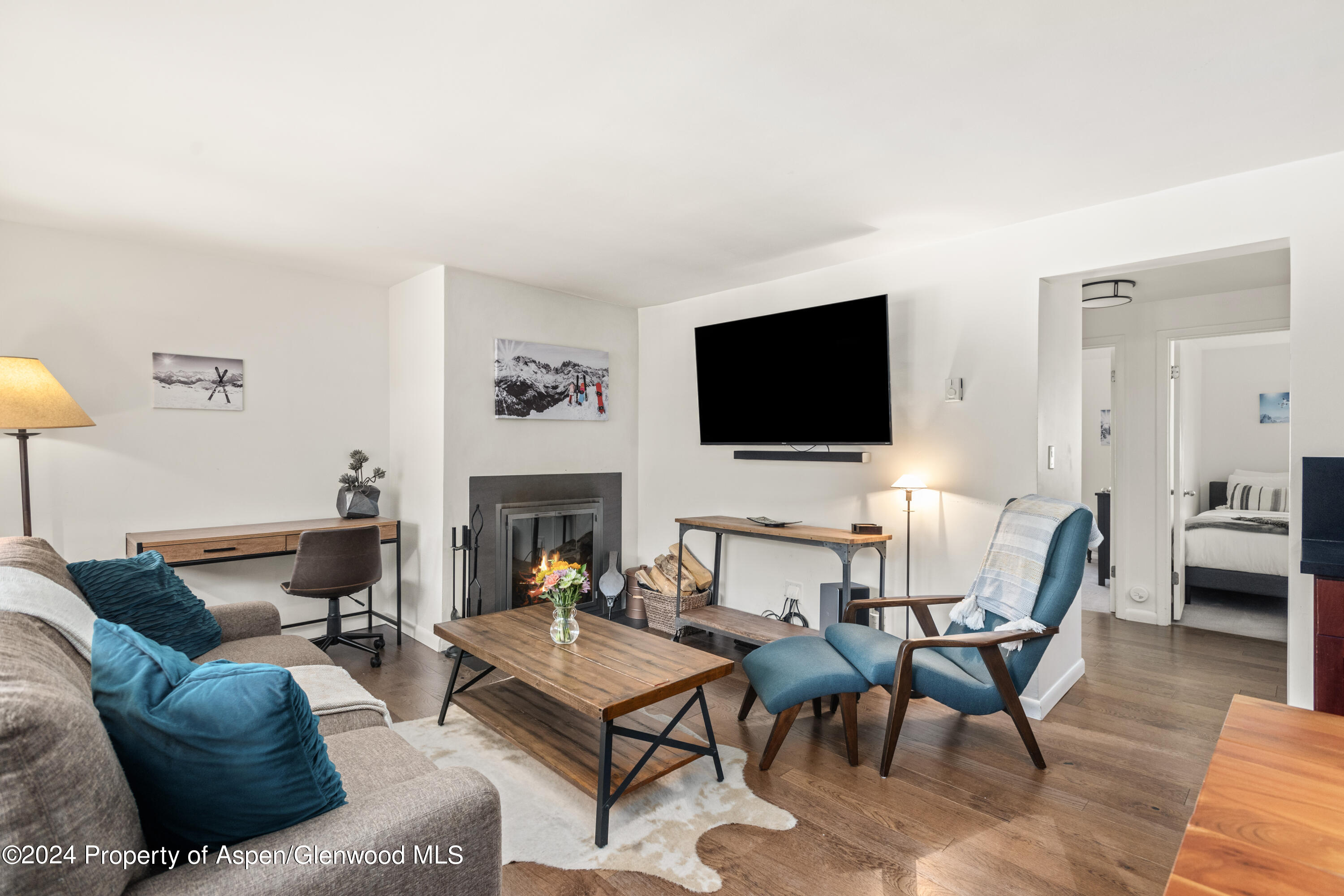 a living room with furniture a fireplace and a flat screen tv