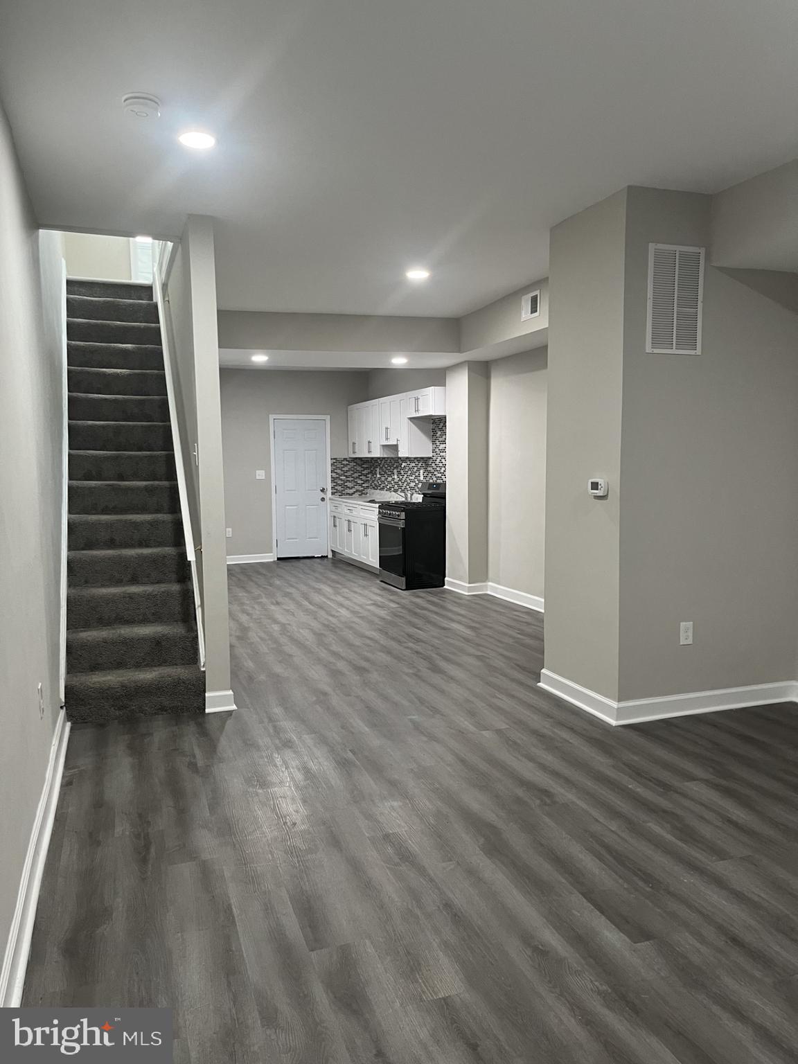 a view of a livingroom with an empty space and a fireplace