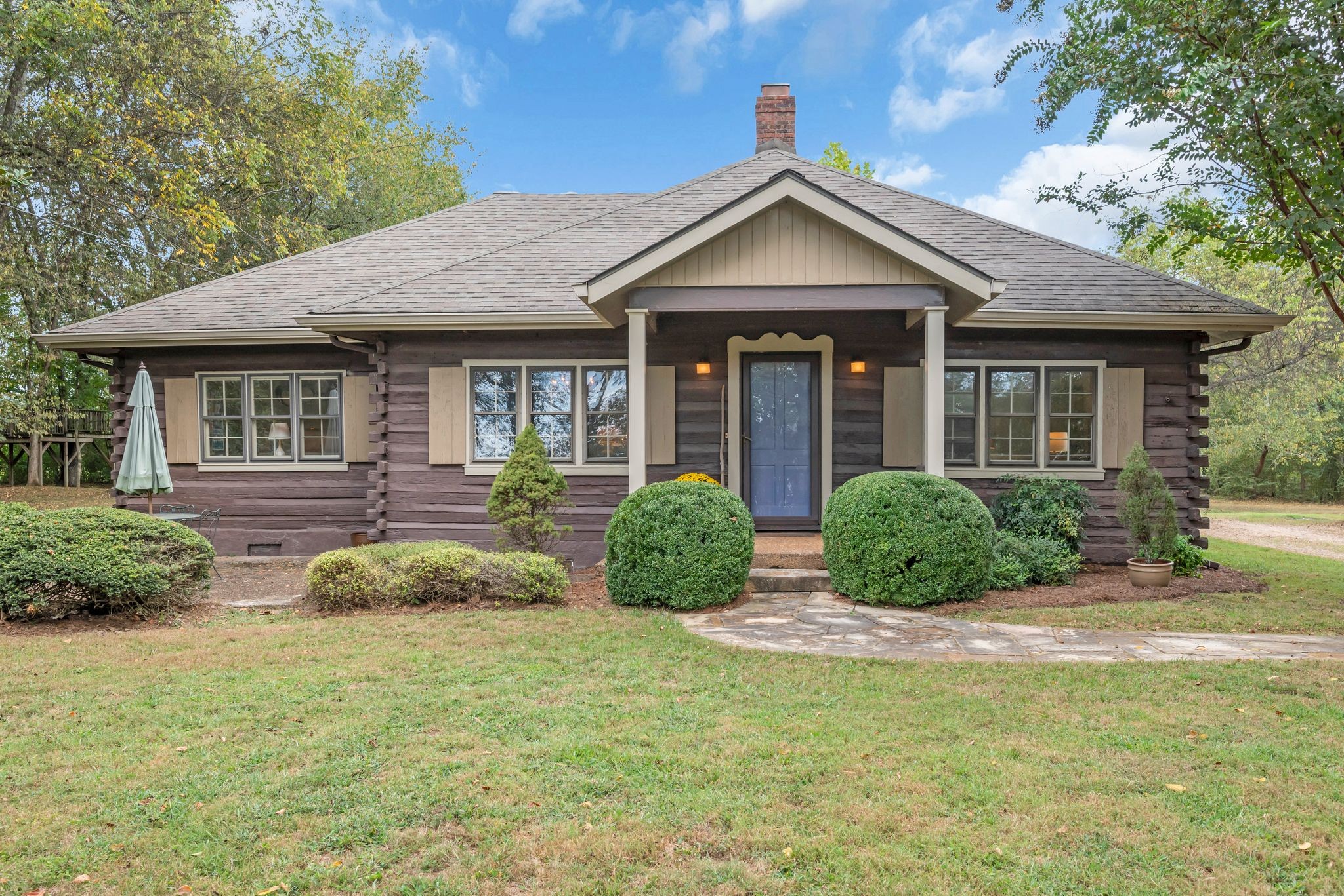 a front view of a house with garden