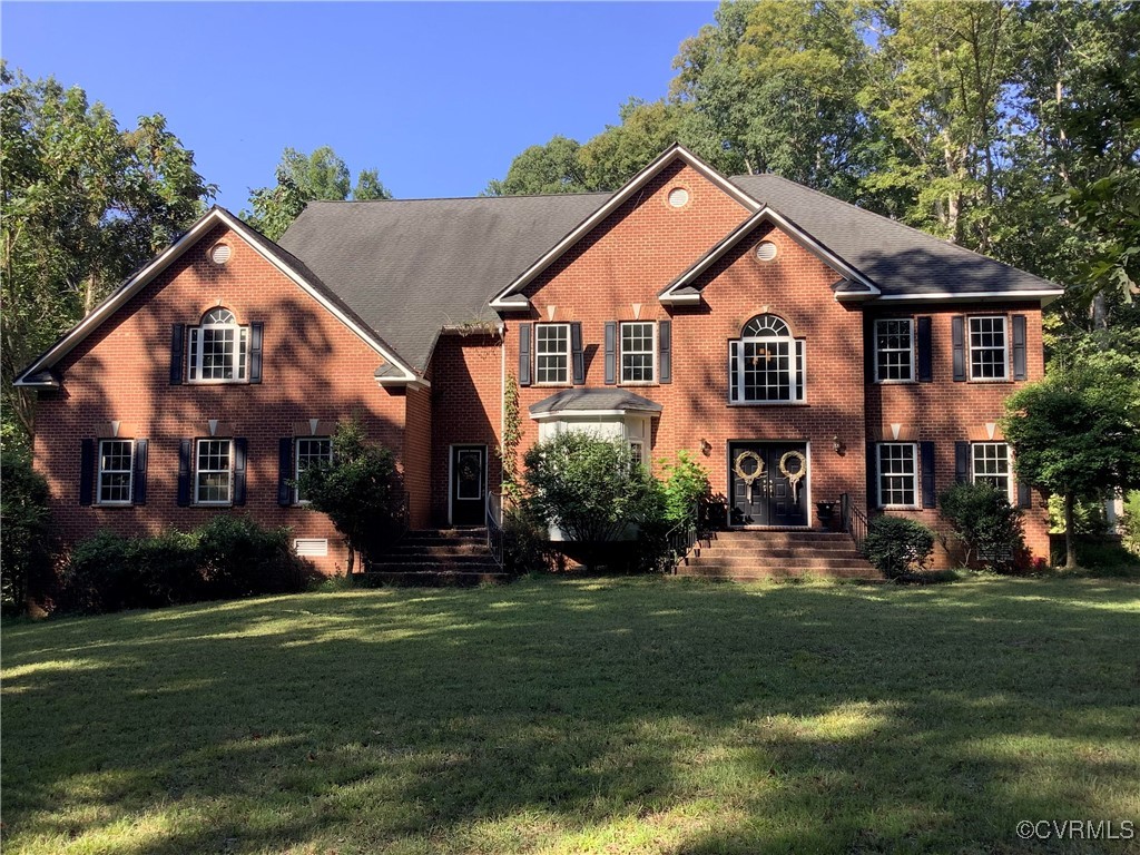 Colonial home with a front lawn