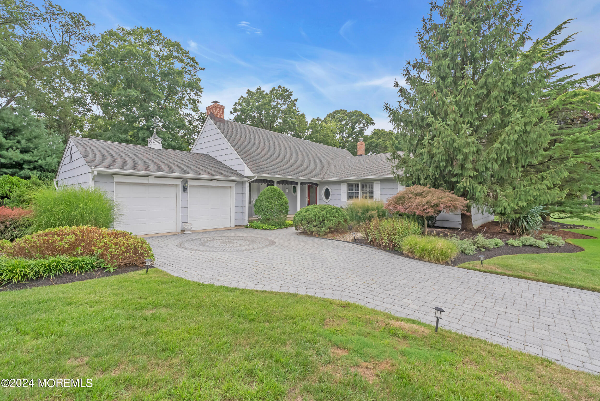 a view of a house with a yard and a garage