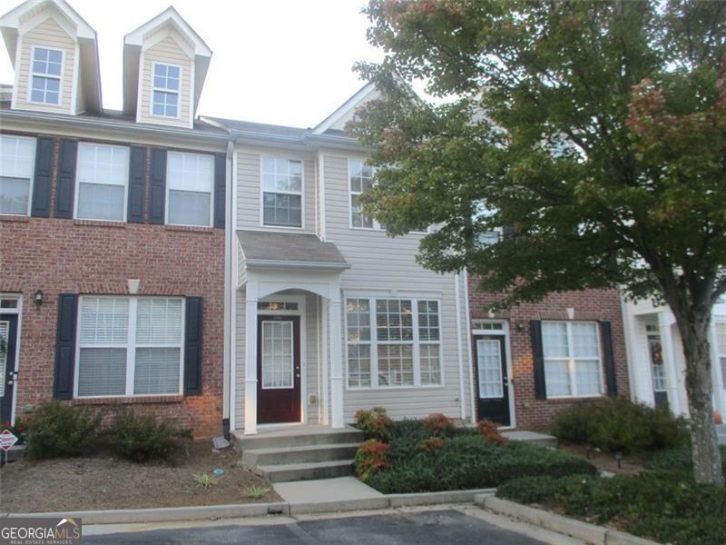 a front view of a house with a garden and garage