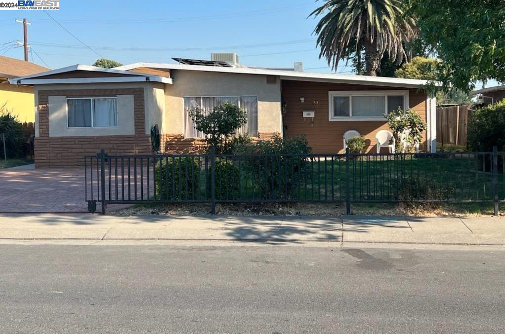 a view of house with small yard next to a road