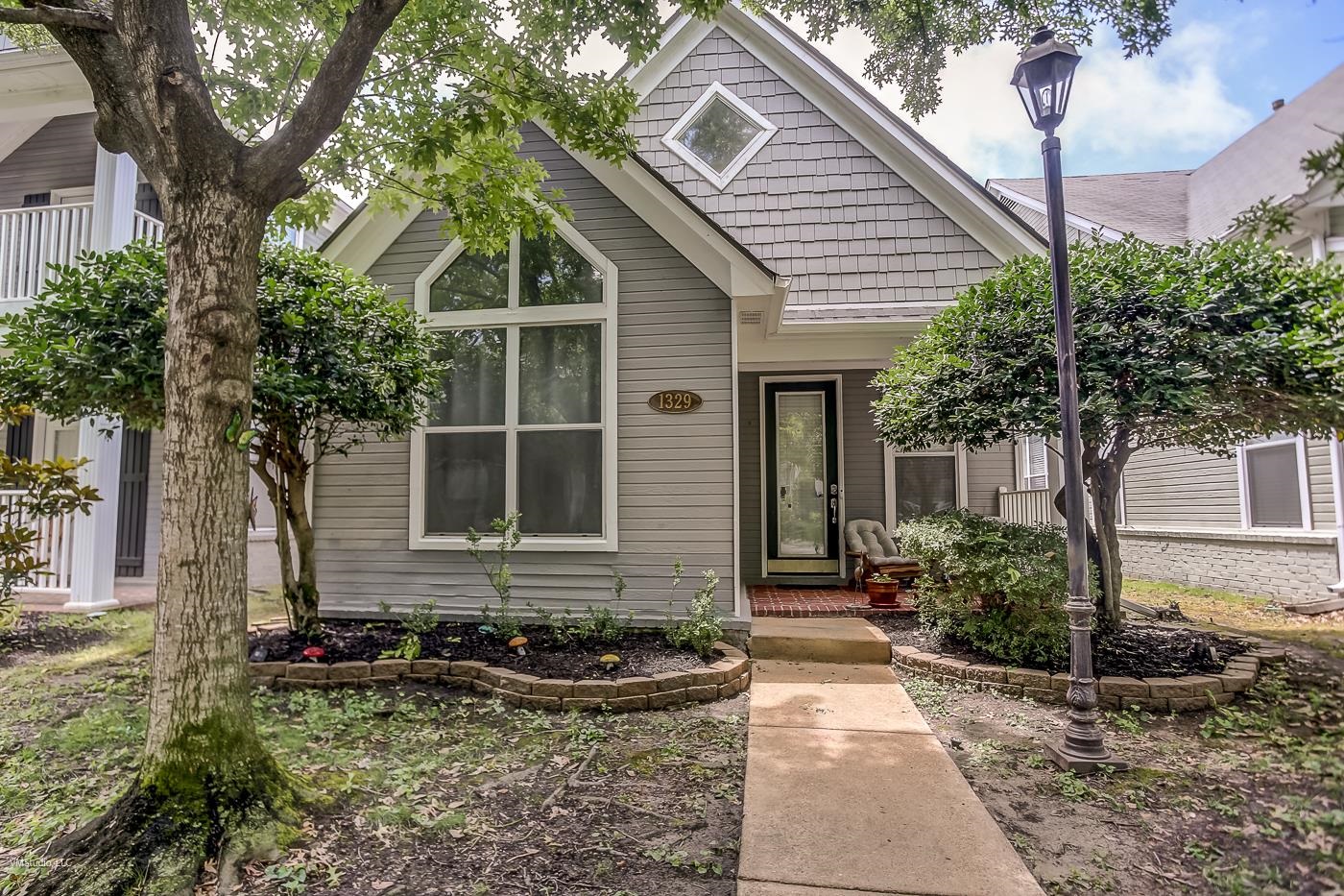 a front view of a house with garden