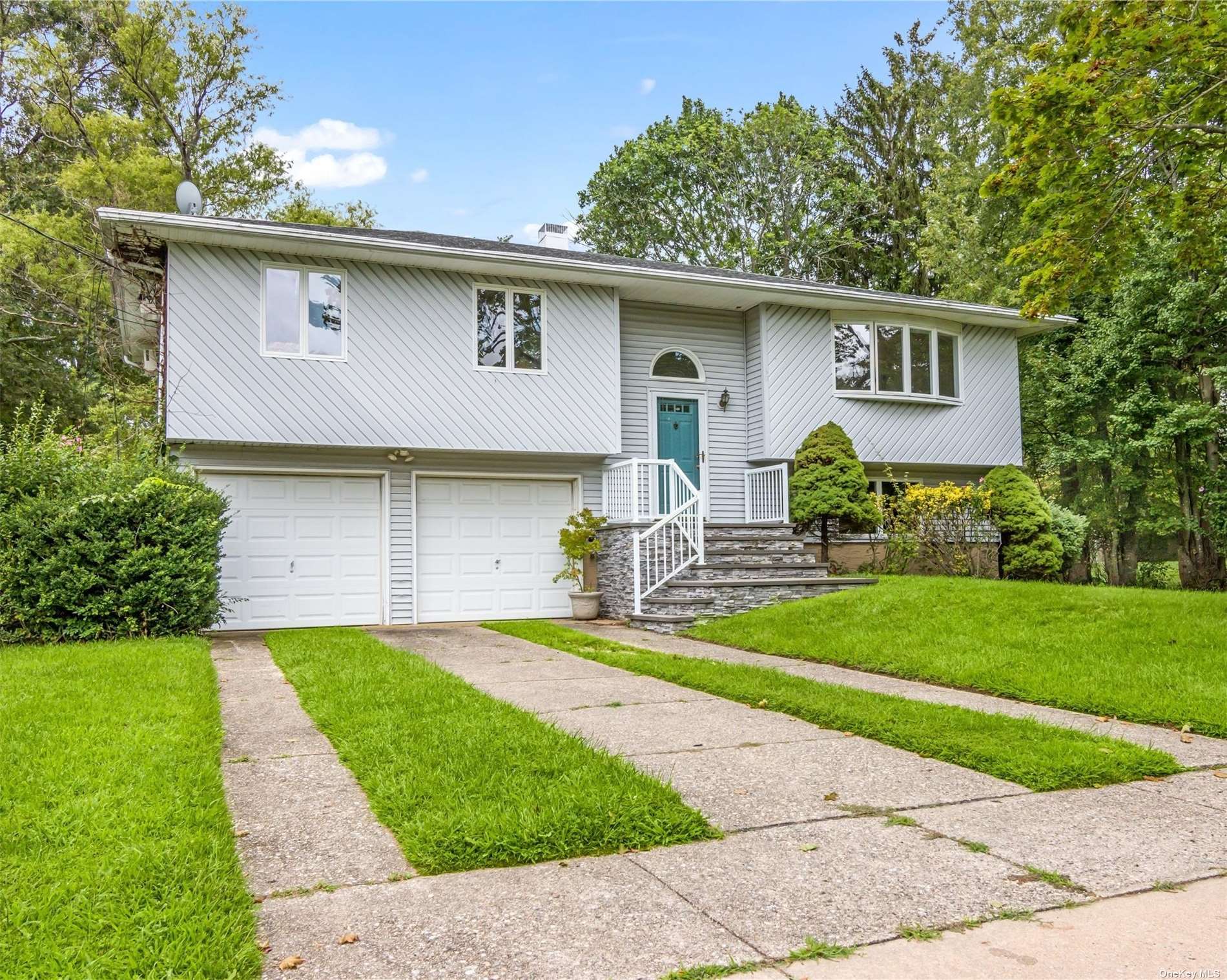 a front view of house with yard and green space