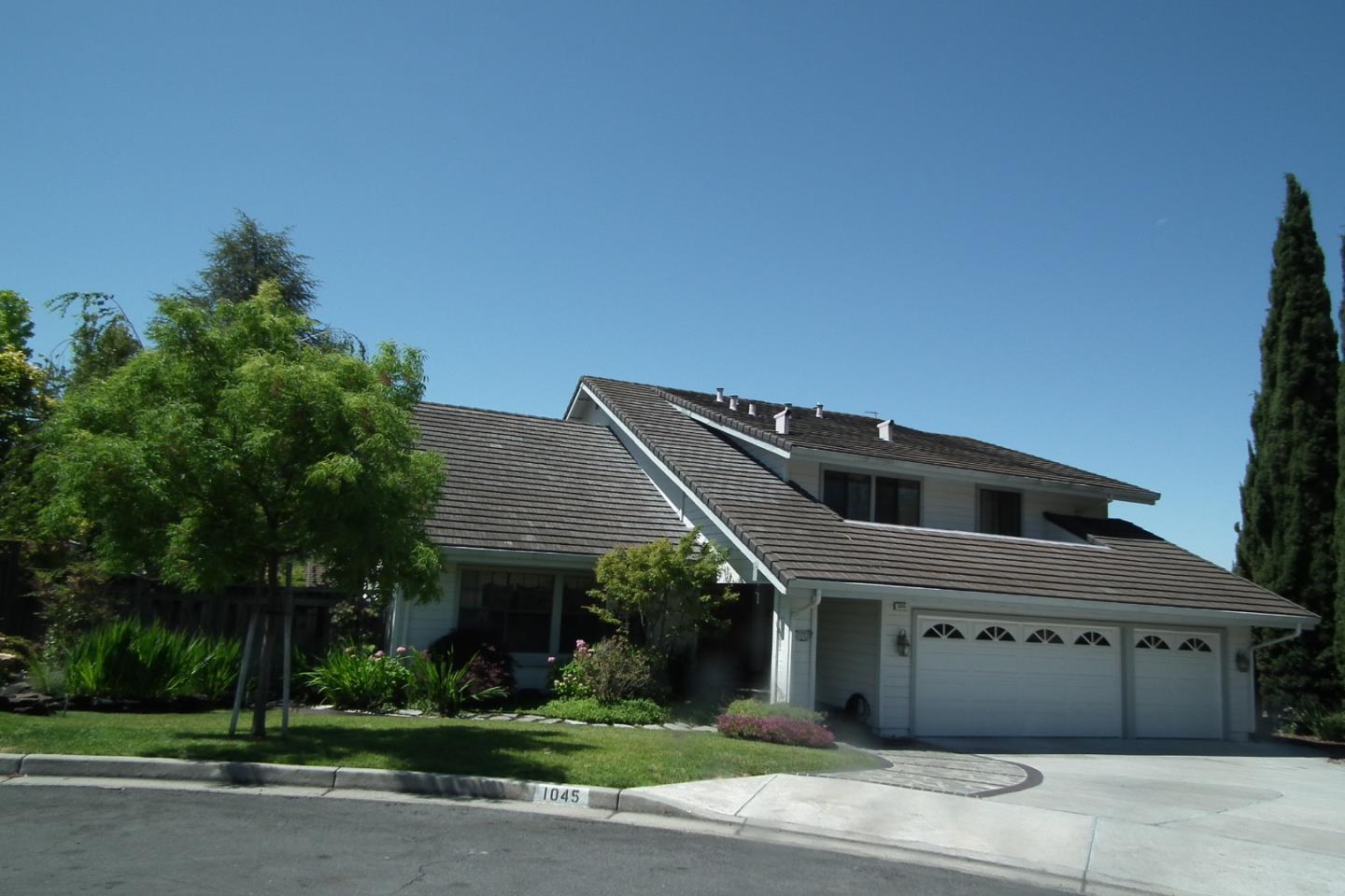 a front view of a house with a garden