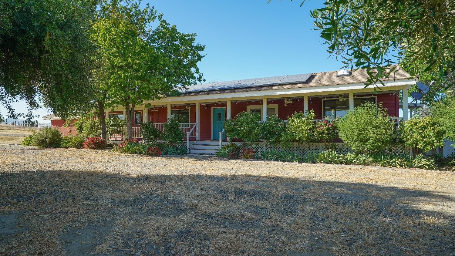 a view of a house with a yard and potted plants