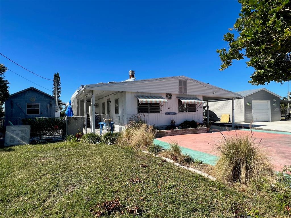 a front view of a house with yard porch and furniture