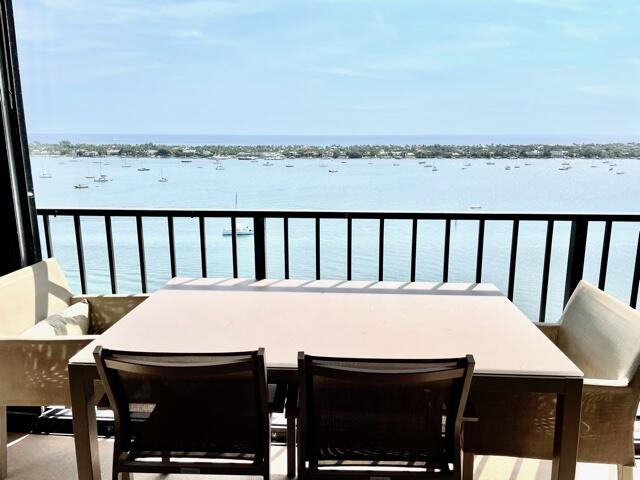 a view of a city from a dining room with furniture