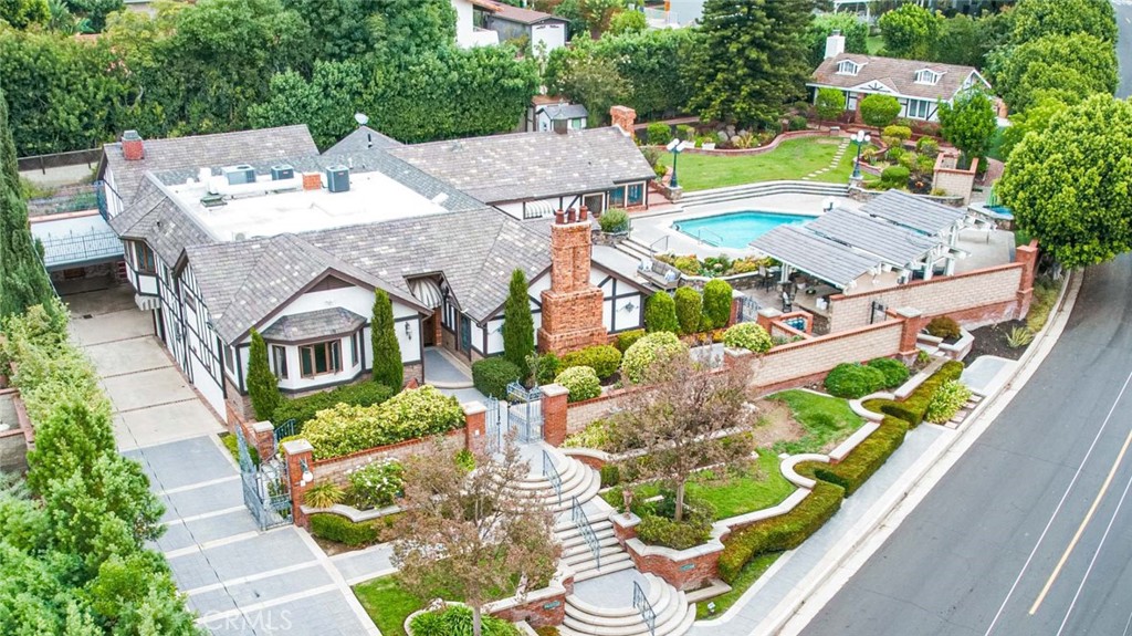 an aerial view of a house with a garden and plants