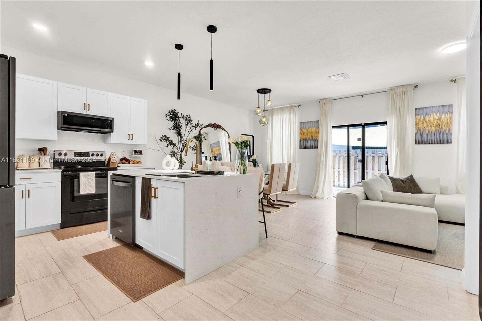 a kitchen with kitchen island white cabinets and stainless steel appliances