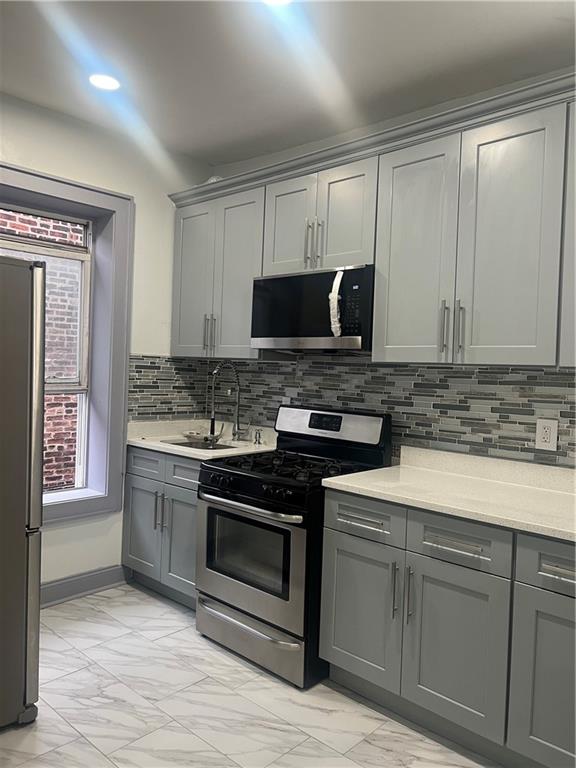 a kitchen with granite countertop a stove and a sink