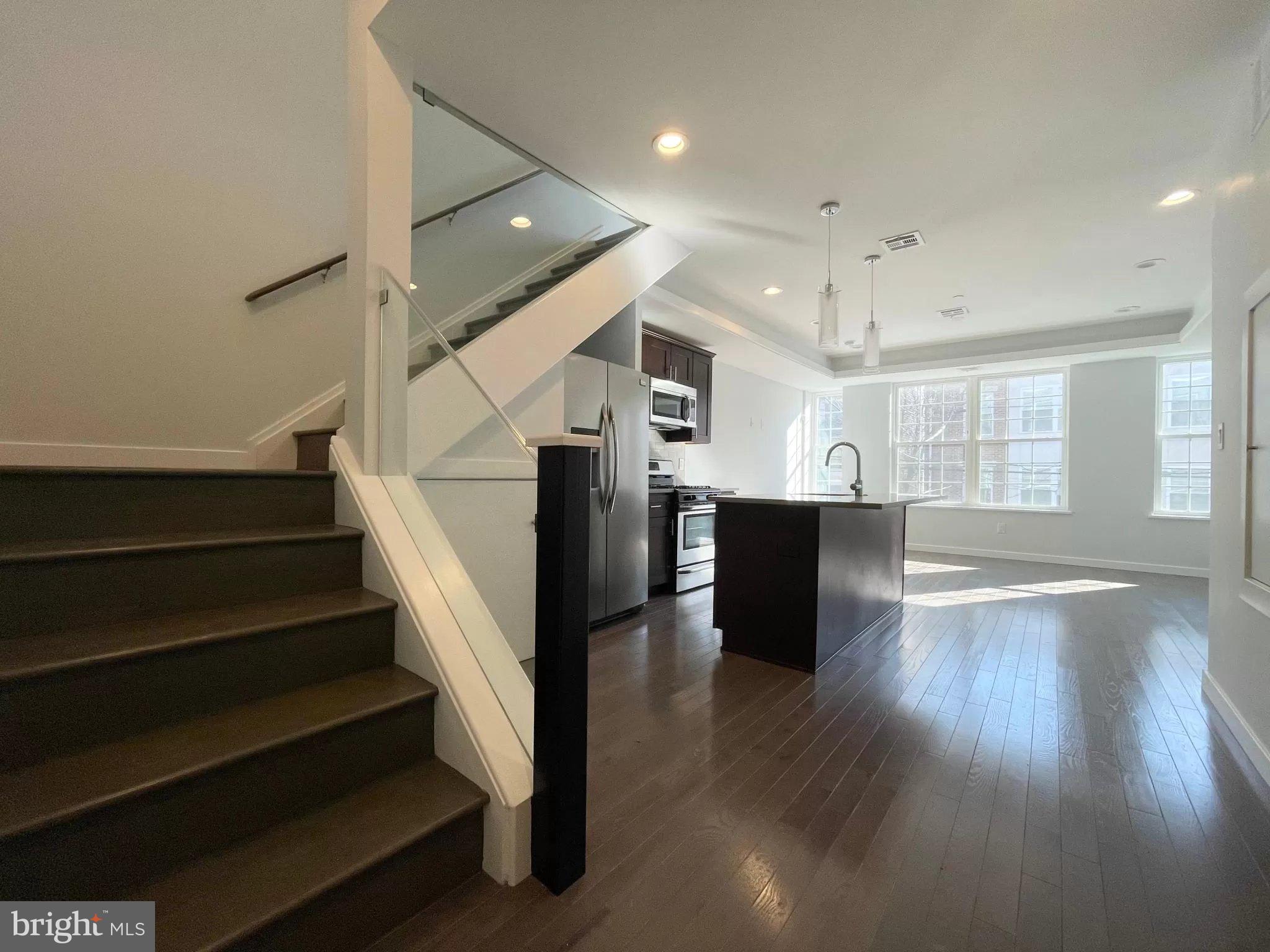 a view of entryway and hall with wooden floor